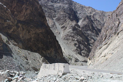 A winding mountain road crossing the Tizi n’Tichka pass with rugged peaks around.