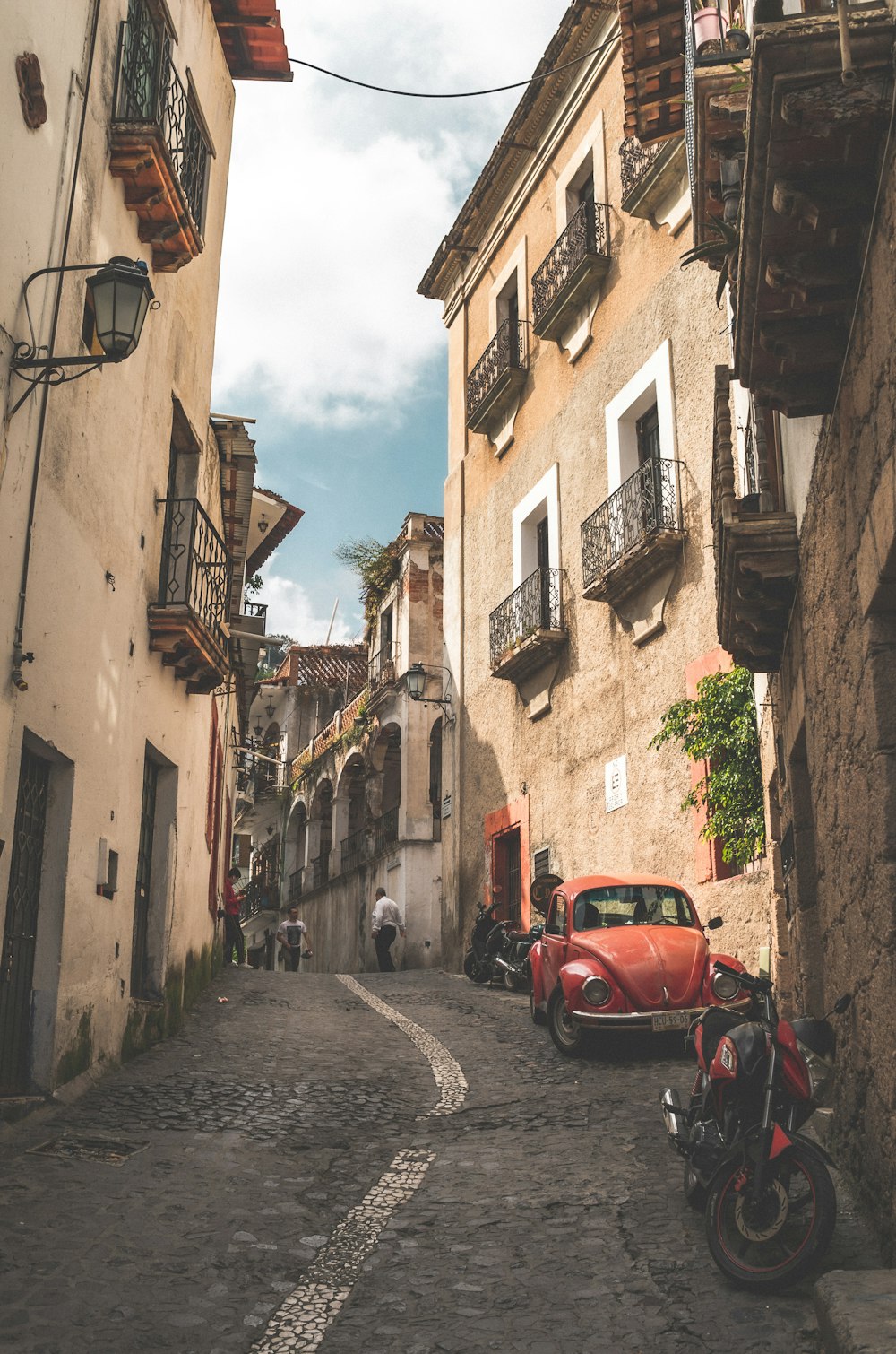 a red car parked on the side of a street