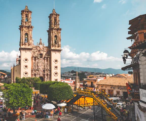 a large cathedral towering over a city filled with people