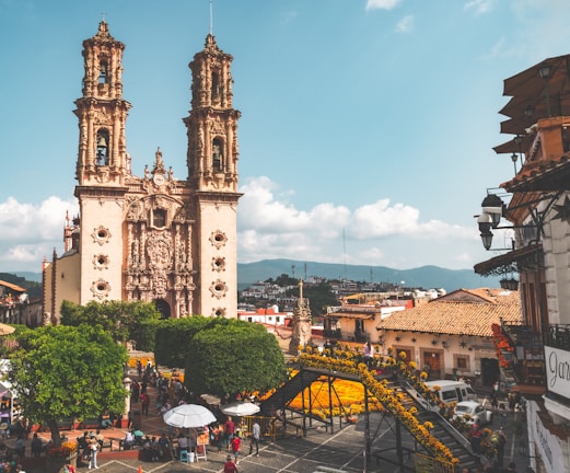 a large cathedral towering over a city filled with people