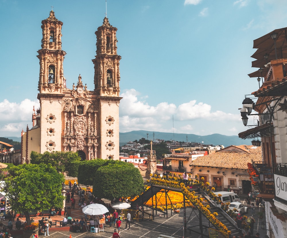 a large cathedral towering over a city filled with people