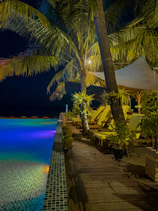 Evening poolside ambiance with ambient lighting at the Godrej Bannerghatta clubhouse.