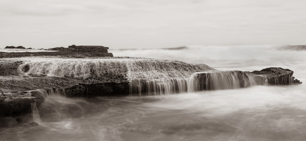 a black and white photo of a waterfall