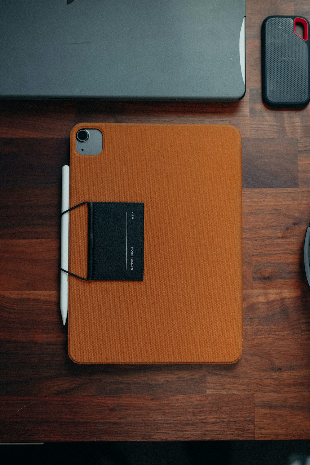 a desk with a mouse, keyboard, and a cell phone