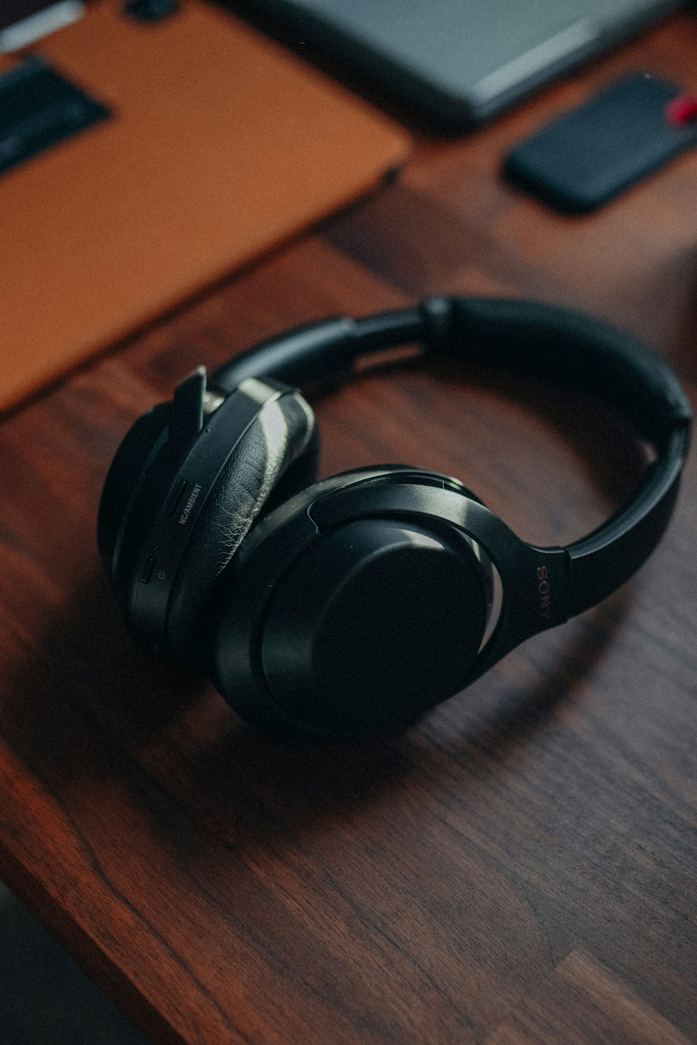 a pair of headphones sitting on top of a wooden desk