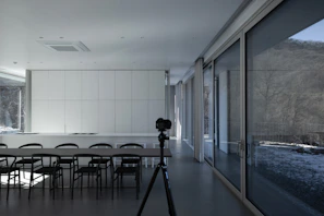 A panoramic shot of a stylish kitchen and dining area rendered in a photorealistic 3D model for real estate marketing.