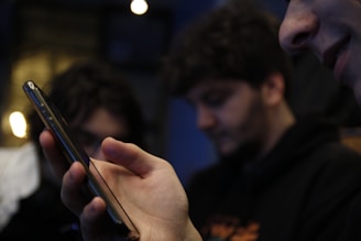 A close-up view of a hands holding a smartphone displaying an app.