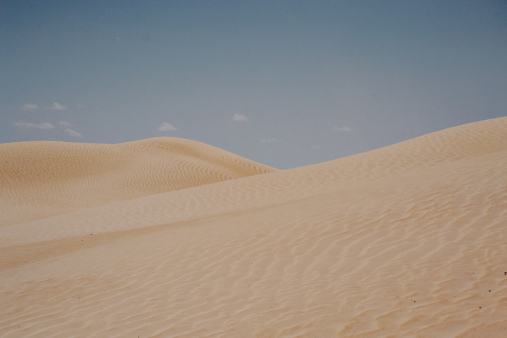 a large sand dune with a sky background