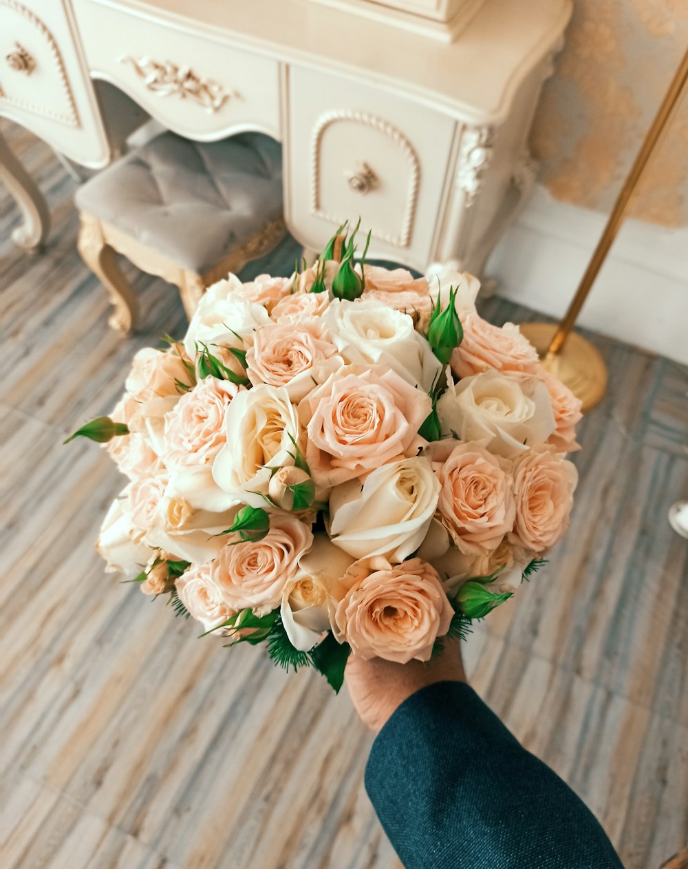 a person holding a bouquet of flowers in their hand