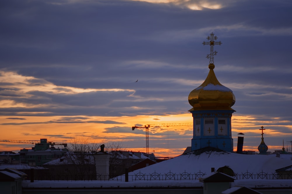 a building with a golden roof and a cross on top