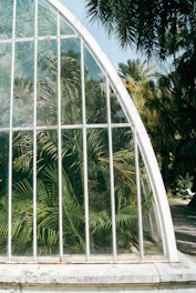 Close-up of polycarbonate panels being installed with precision on a greenhouse roof.