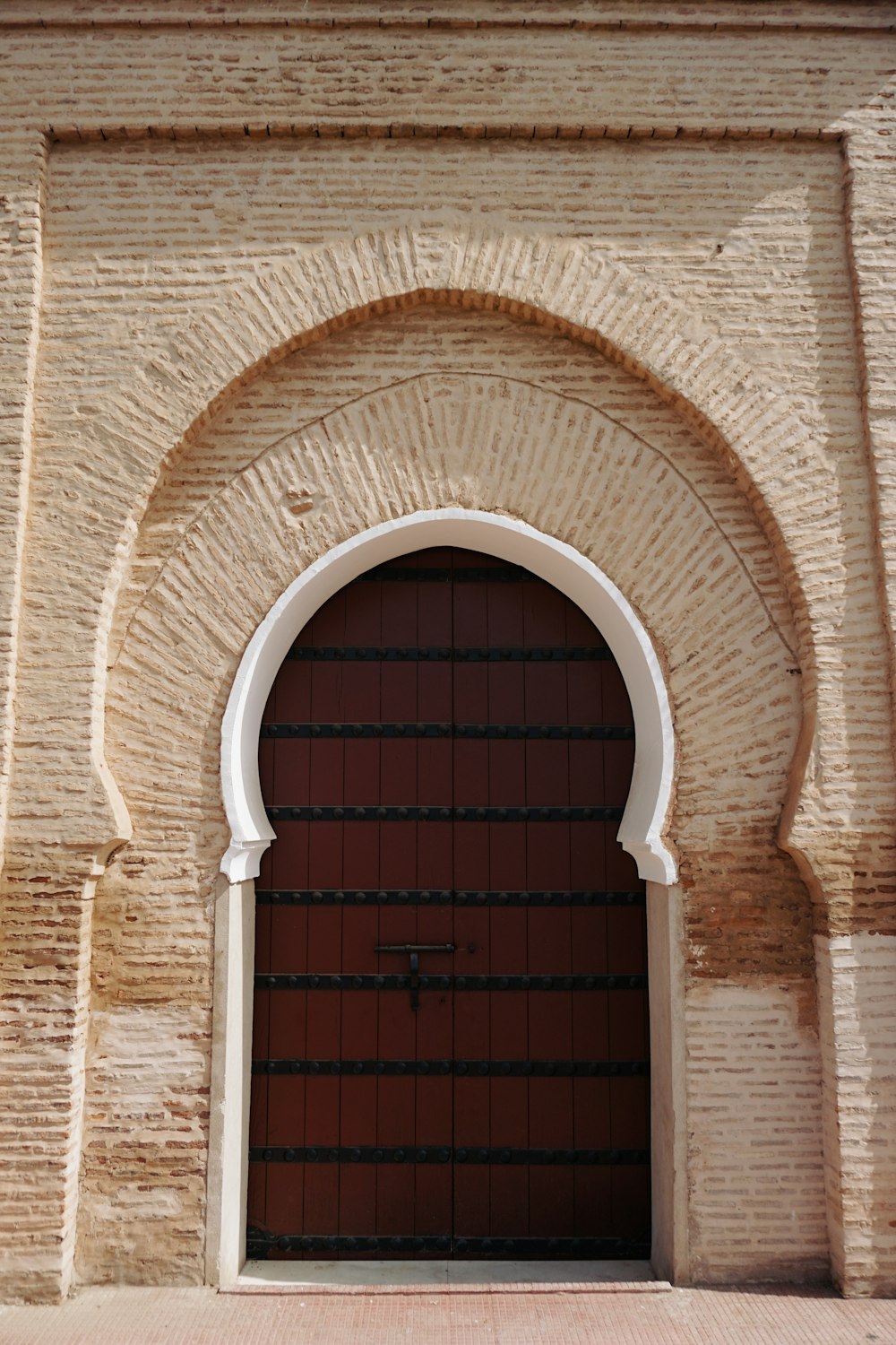 a large brick building with a red door