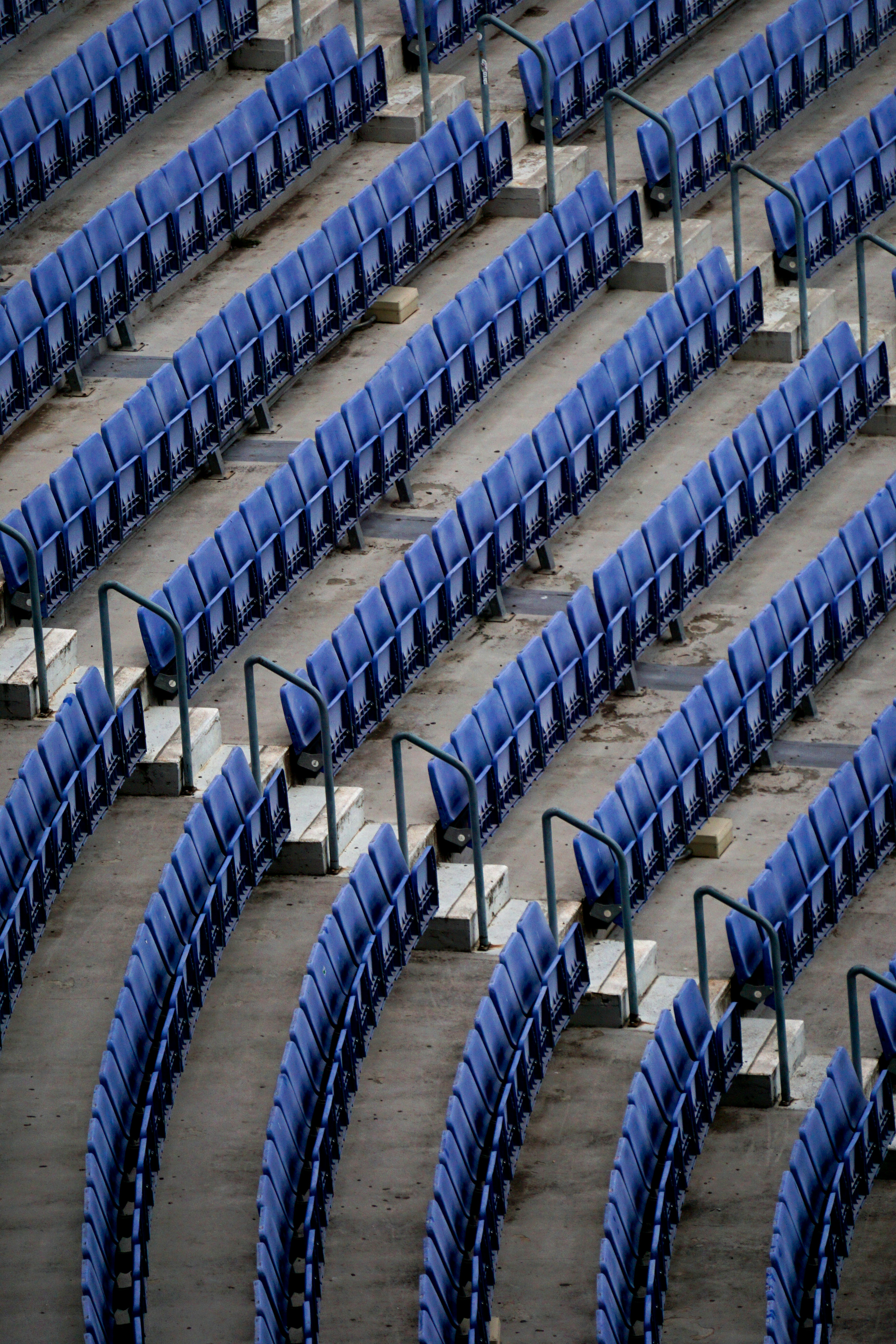 a row of blue seats sitting next to each other