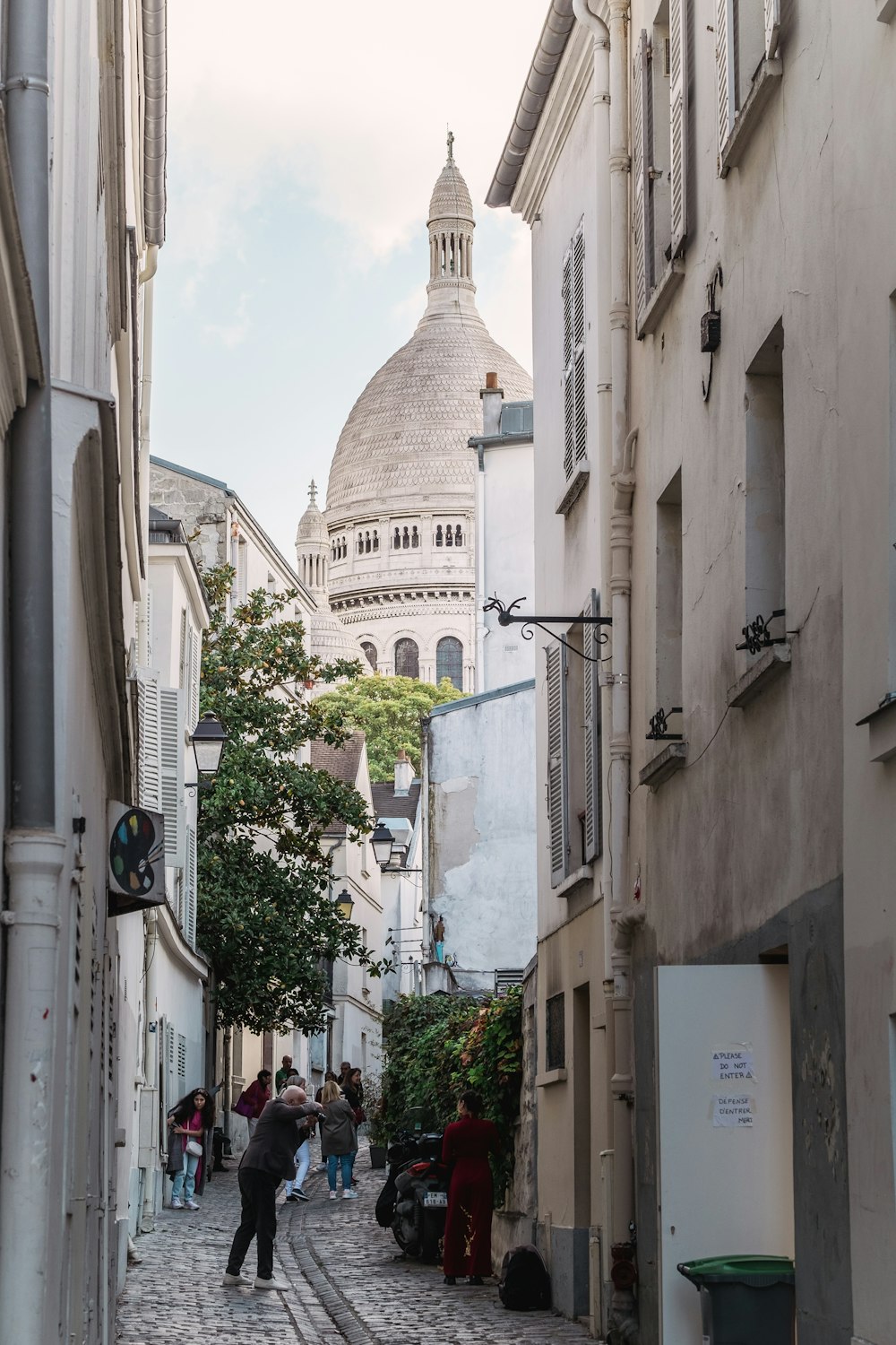 a cobblestone street with people walking on it