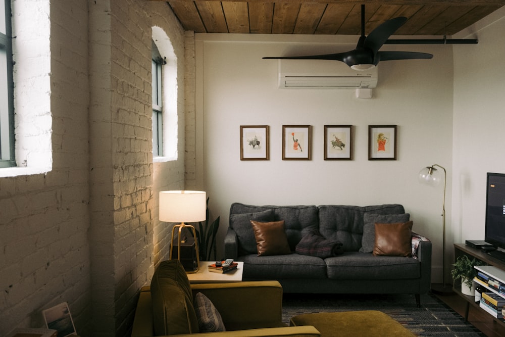 a living room with a gray couch and a flat screen tv