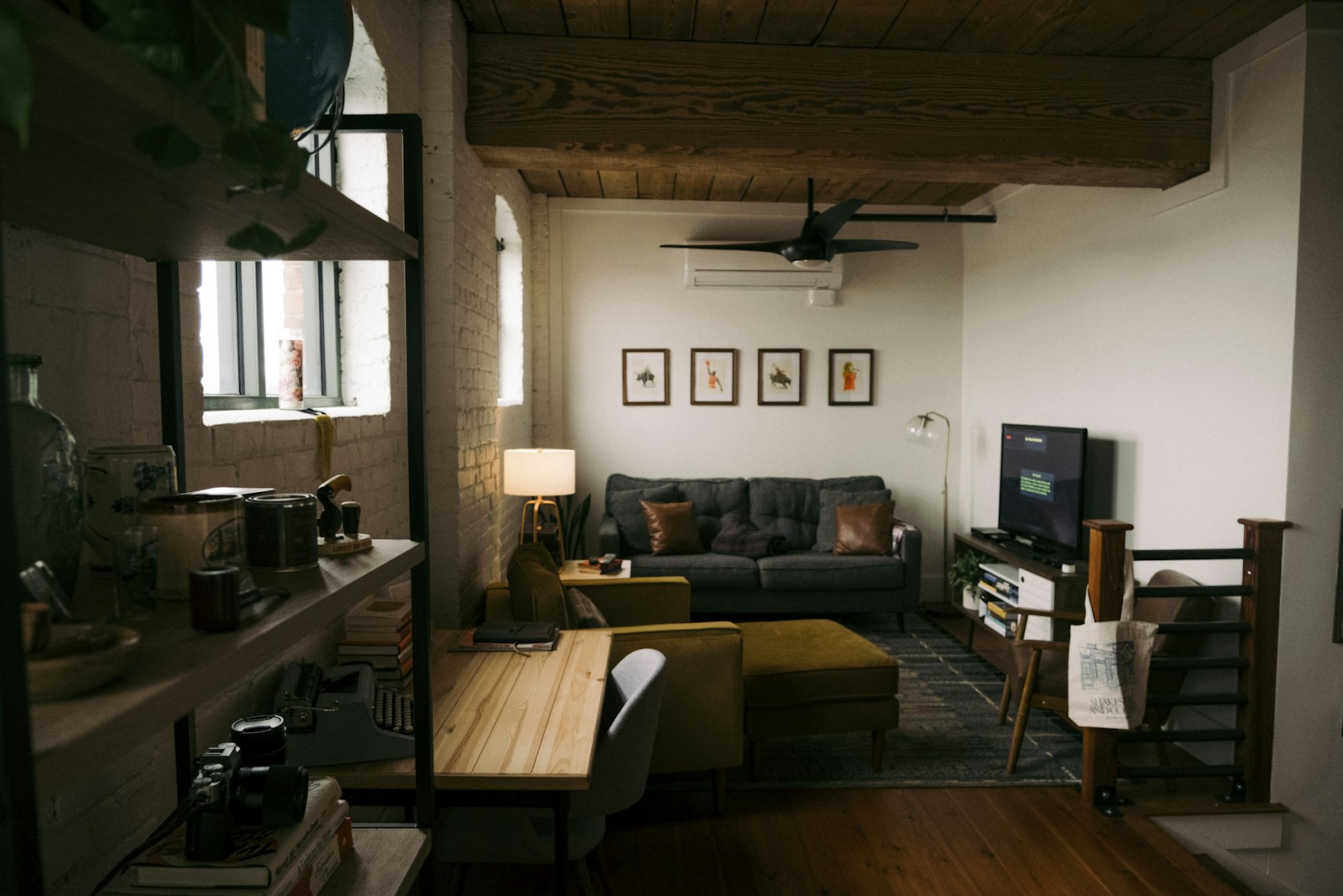 small loft apartment for two with sofa, desk and gallery wall