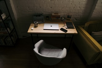 a laptop computer sitting on top of a wooden desk