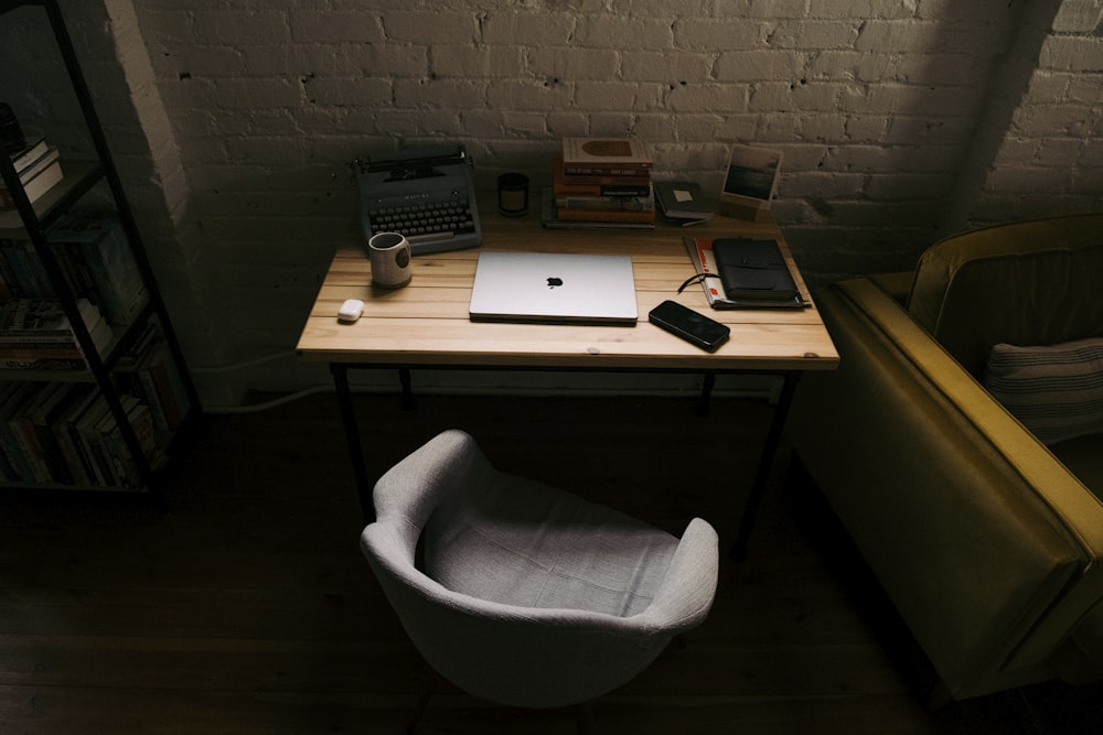 a laptop computer sitting on top of a wooden desk