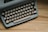 an old fashioned typewriter sitting on a wooden table