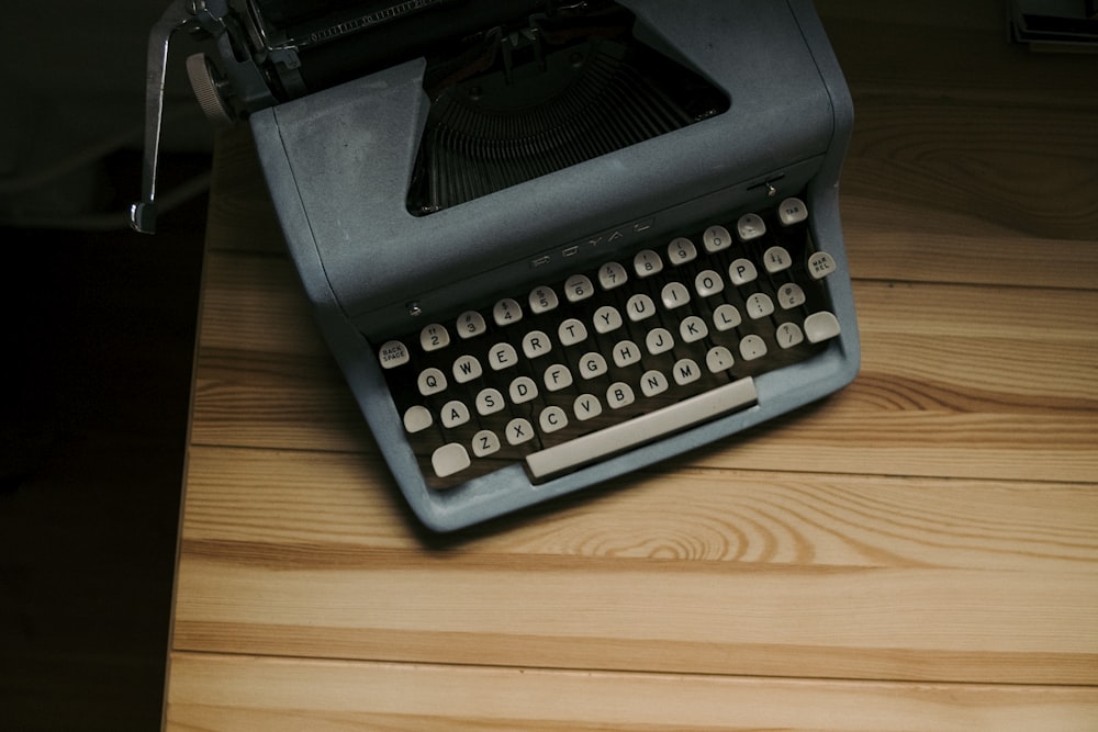 an old fashioned typewriter sitting on a wooden table