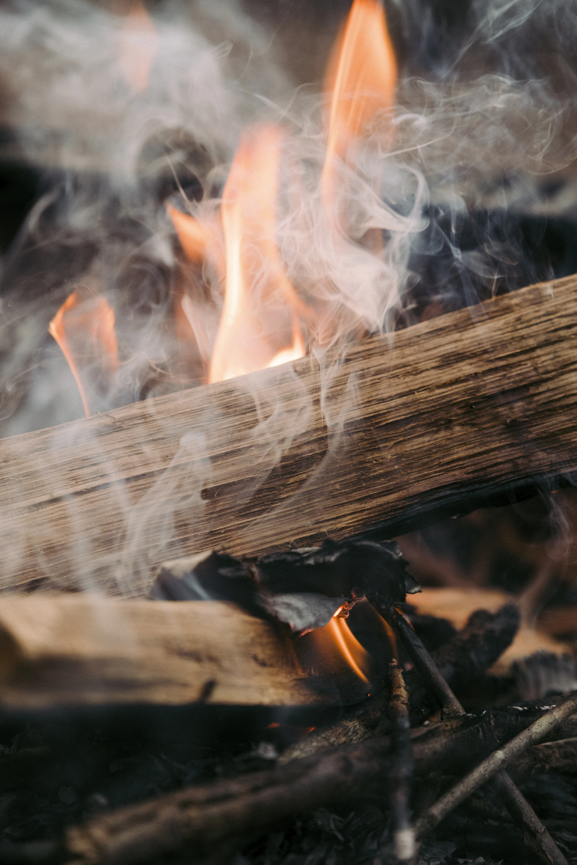 a close up of a fire with smoke coming out of it
