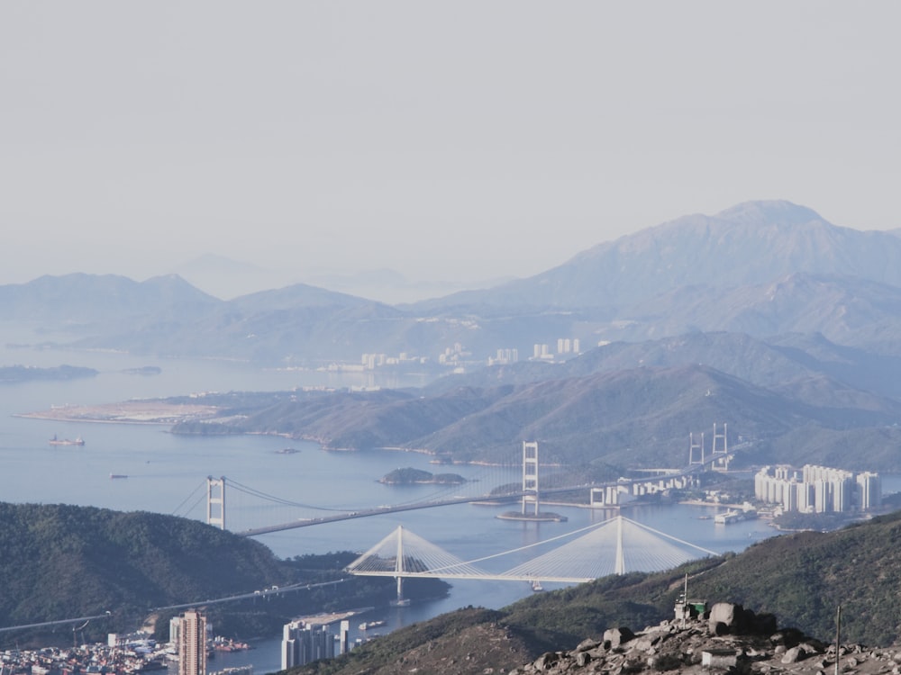 a view of a city and a bridge from a hill