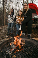 Children and adults sharing stories around a campfire.