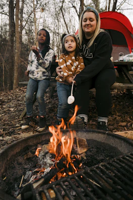 A family gathered around a campfire sharing stories and roasting marshmallows.