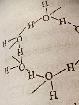 Close-up of a molecular model representing hormones interacting with fat cells.