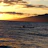 Solo kayaker paddling through calm mangrove waters with a golden sunset sky.