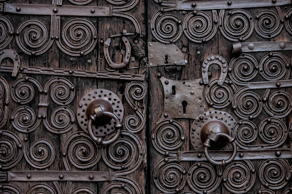 a close up of a wooden door with metal handles