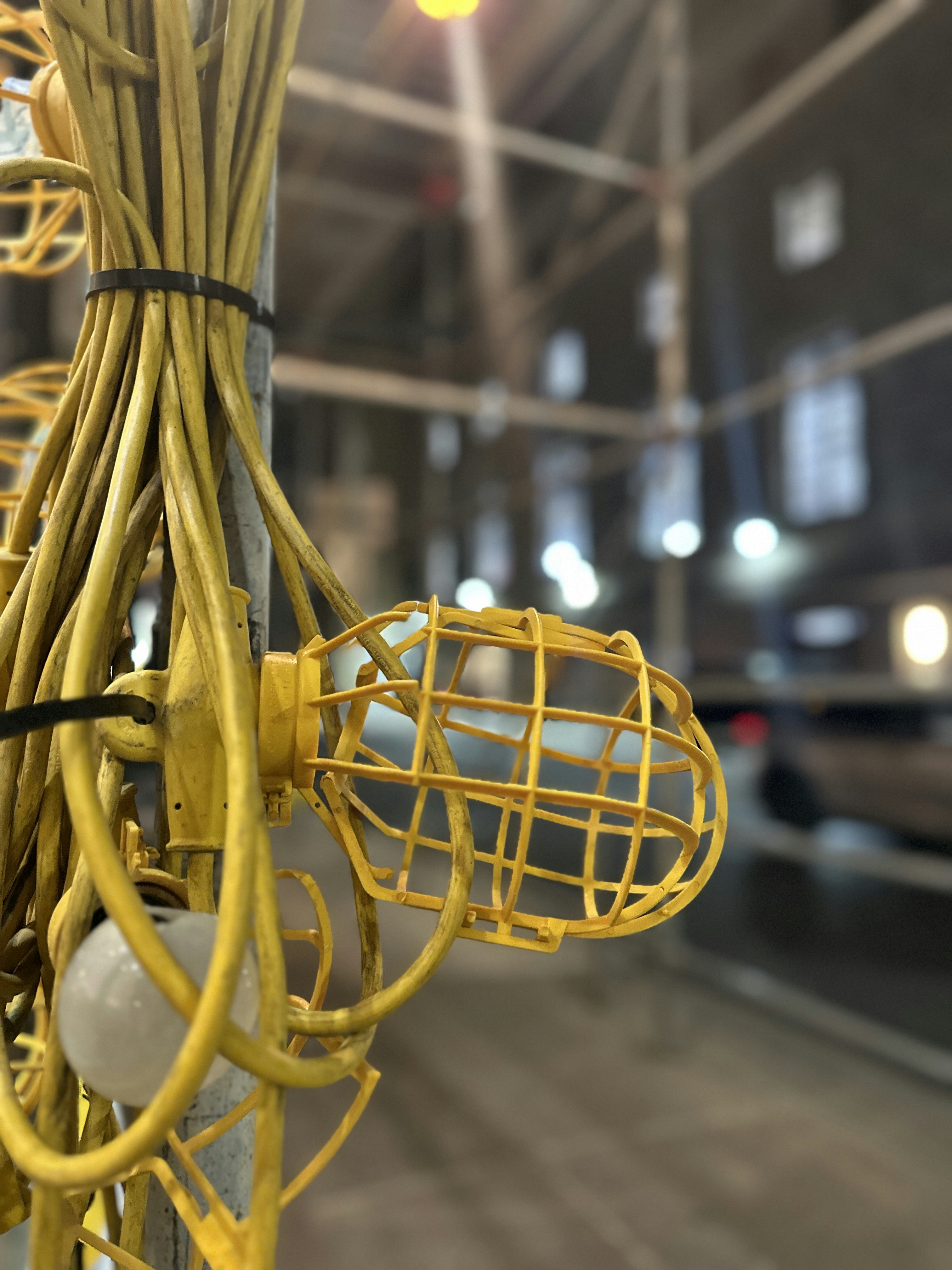 a bunch of yellow wires hanging from a pole