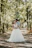 a bride and groom standing in the middle of a forest