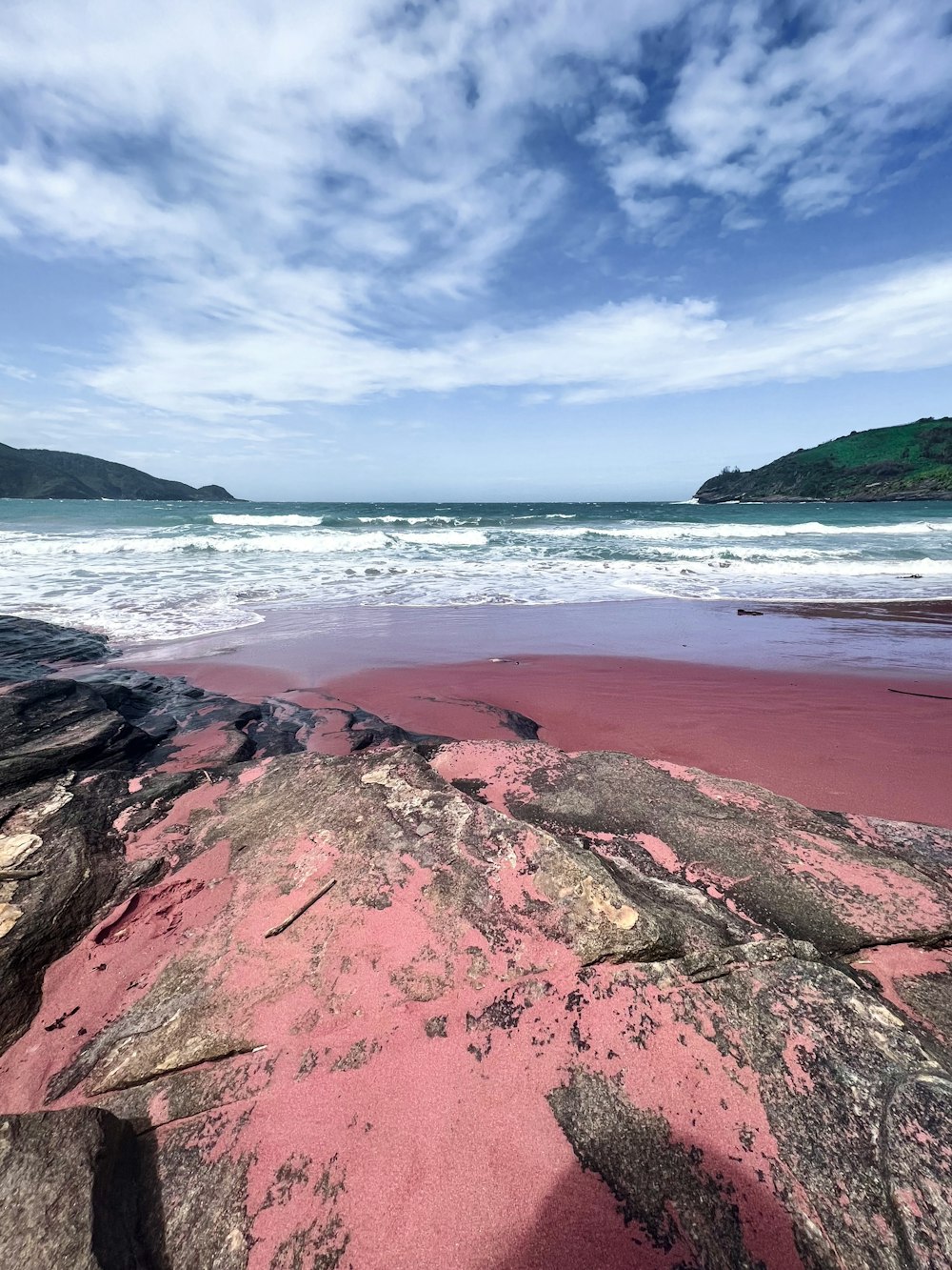 a beach with rocks and a body of water