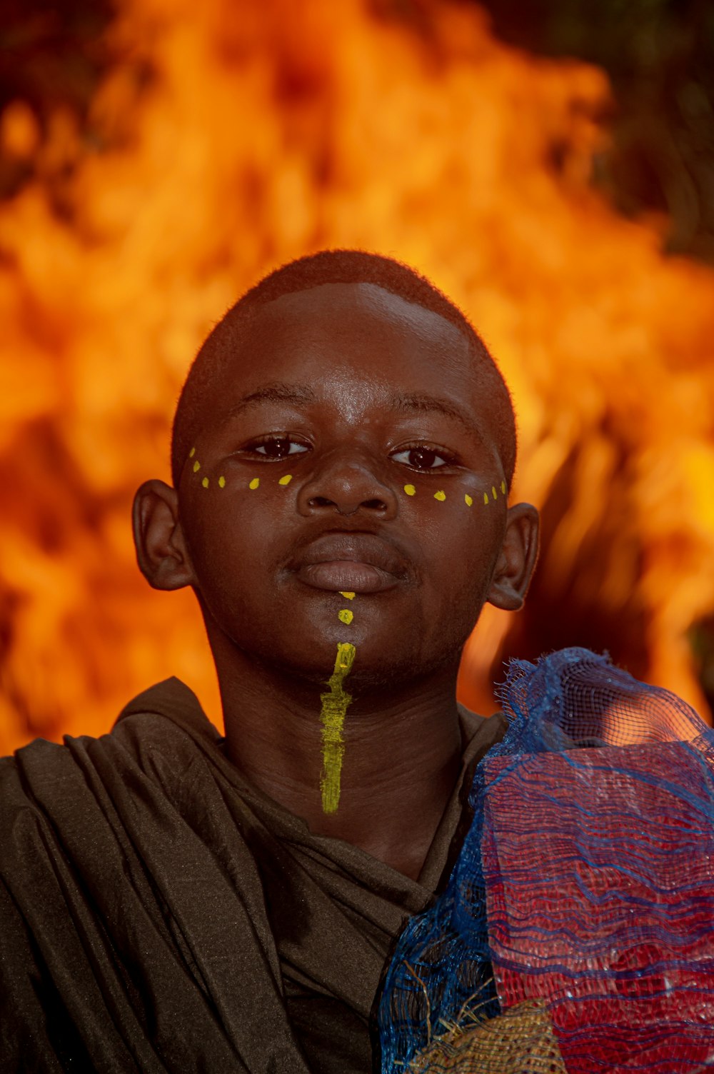 a man standing in front of a fire