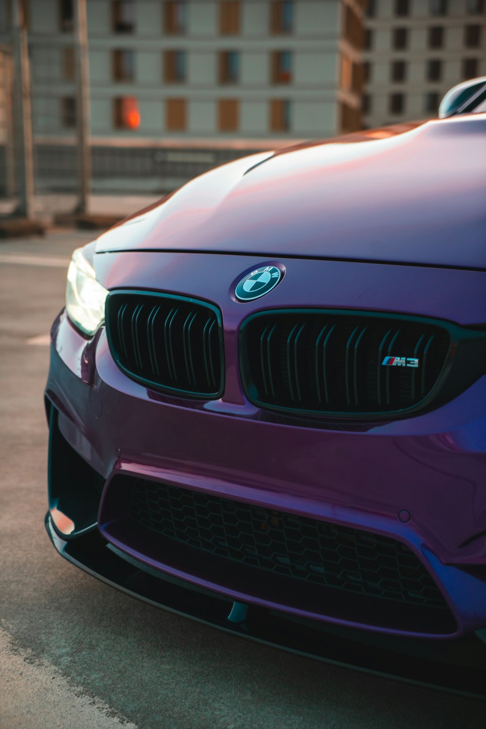 a close up of the front of a purple car