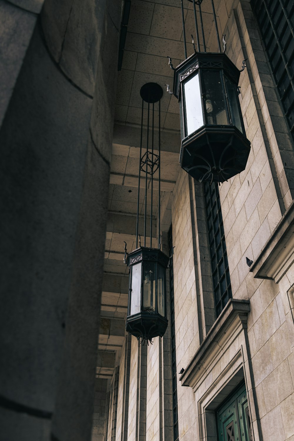 a couple of lights hanging from the side of a building