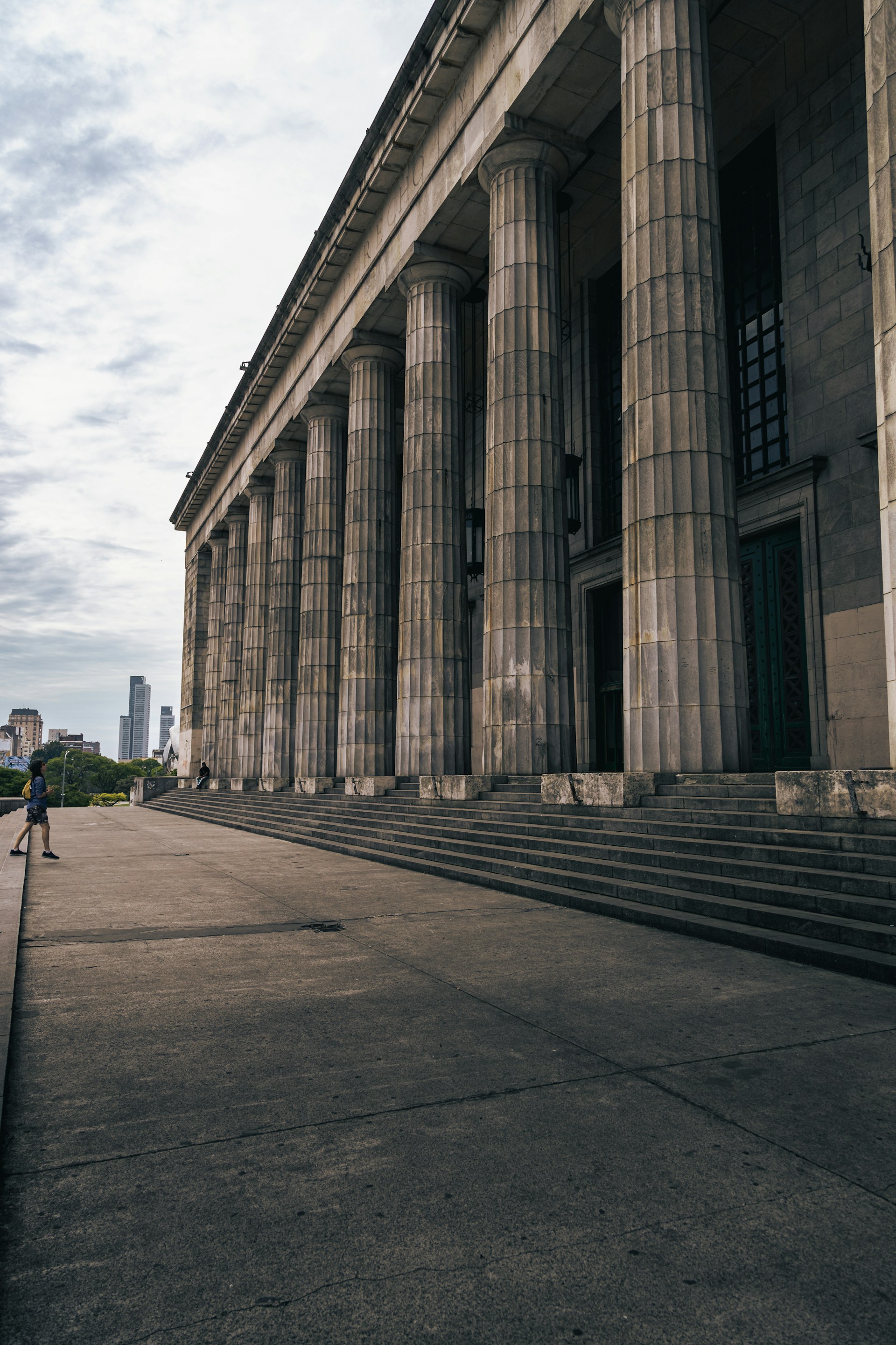 a person standing in front of a large building
