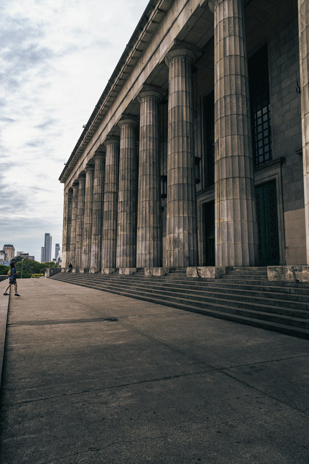 a person standing in front of a large building