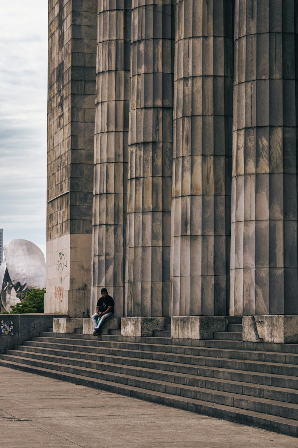 a man sitting on the steps of a building