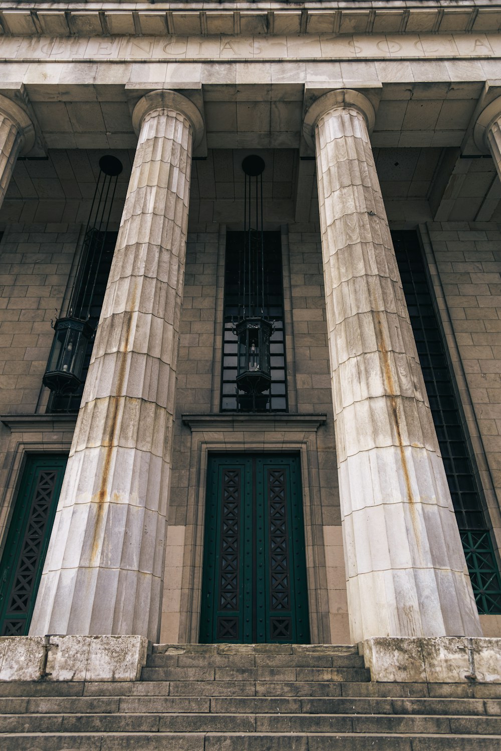 a tall building with two columns and a clock