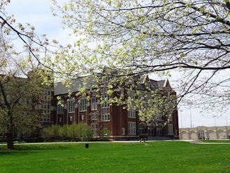a large building with a grassy lawn in front of it