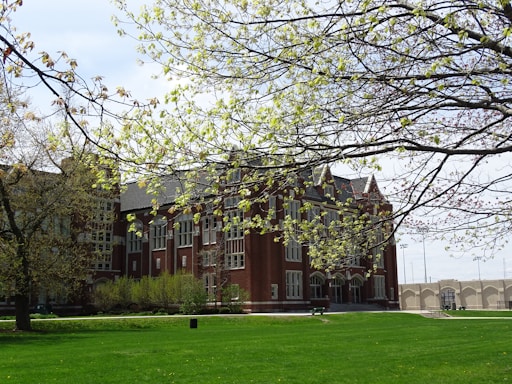 a large building with a grassy lawn in front of it