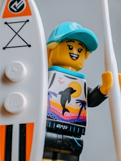 A cheerful customer wearing a matching Lego necklace and bracelet set at a convention.