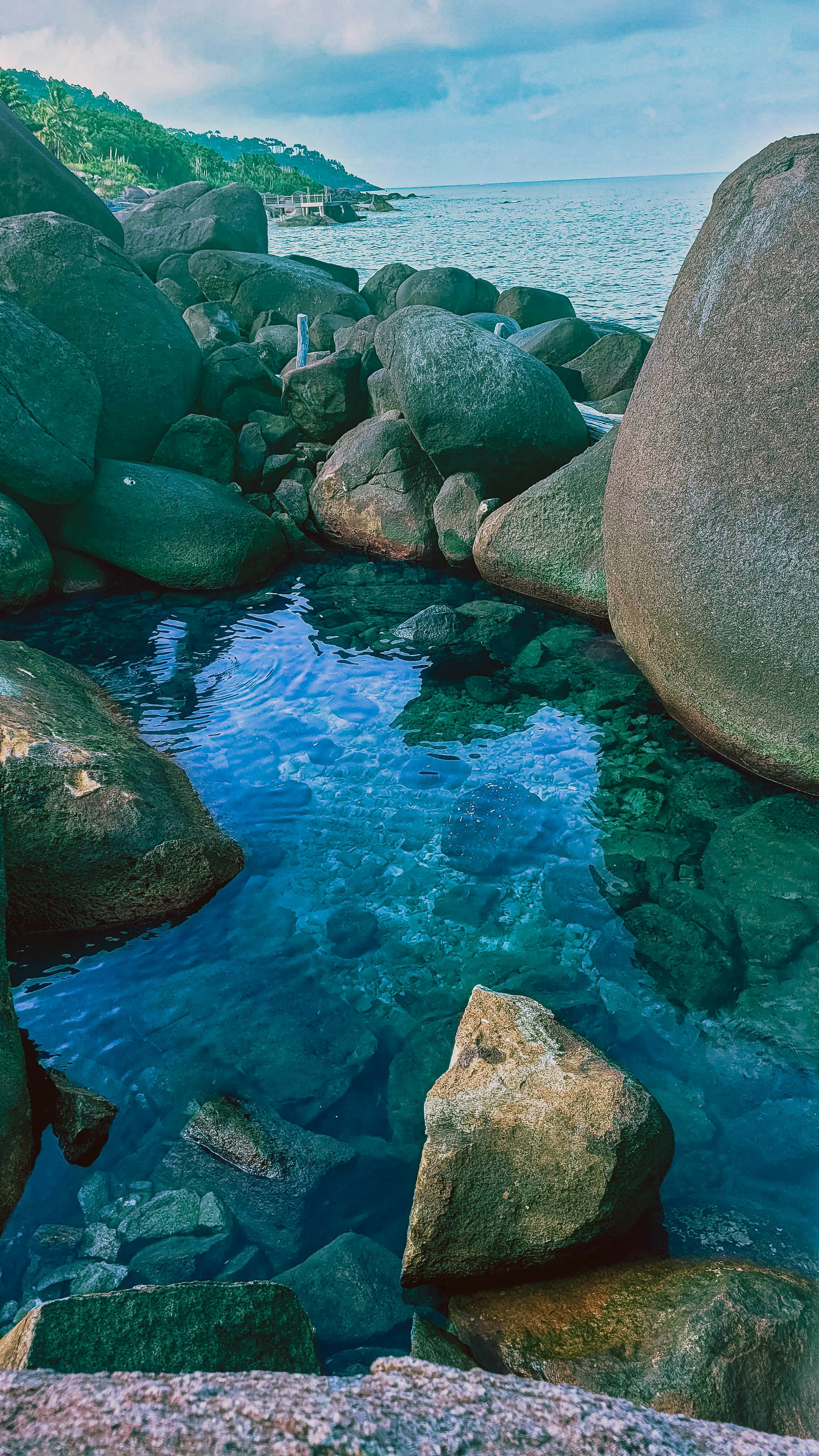 a body of water surrounded by large rocks
