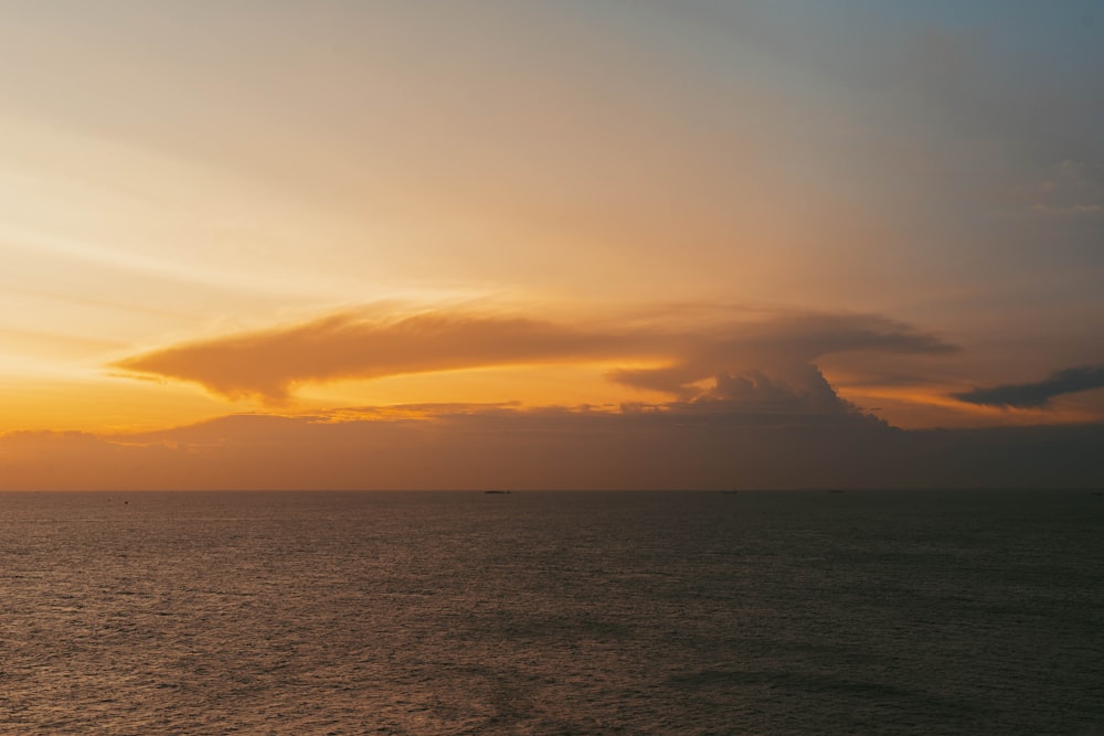 a large body of water under a cloudy sky