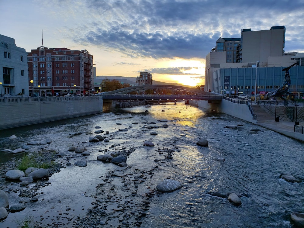 a river running through a city next to tall buildings