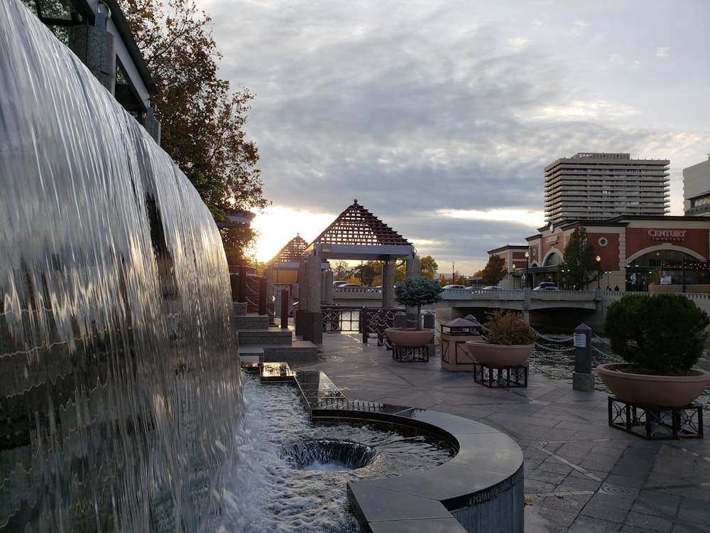 a water fountain in the middle of a plaza