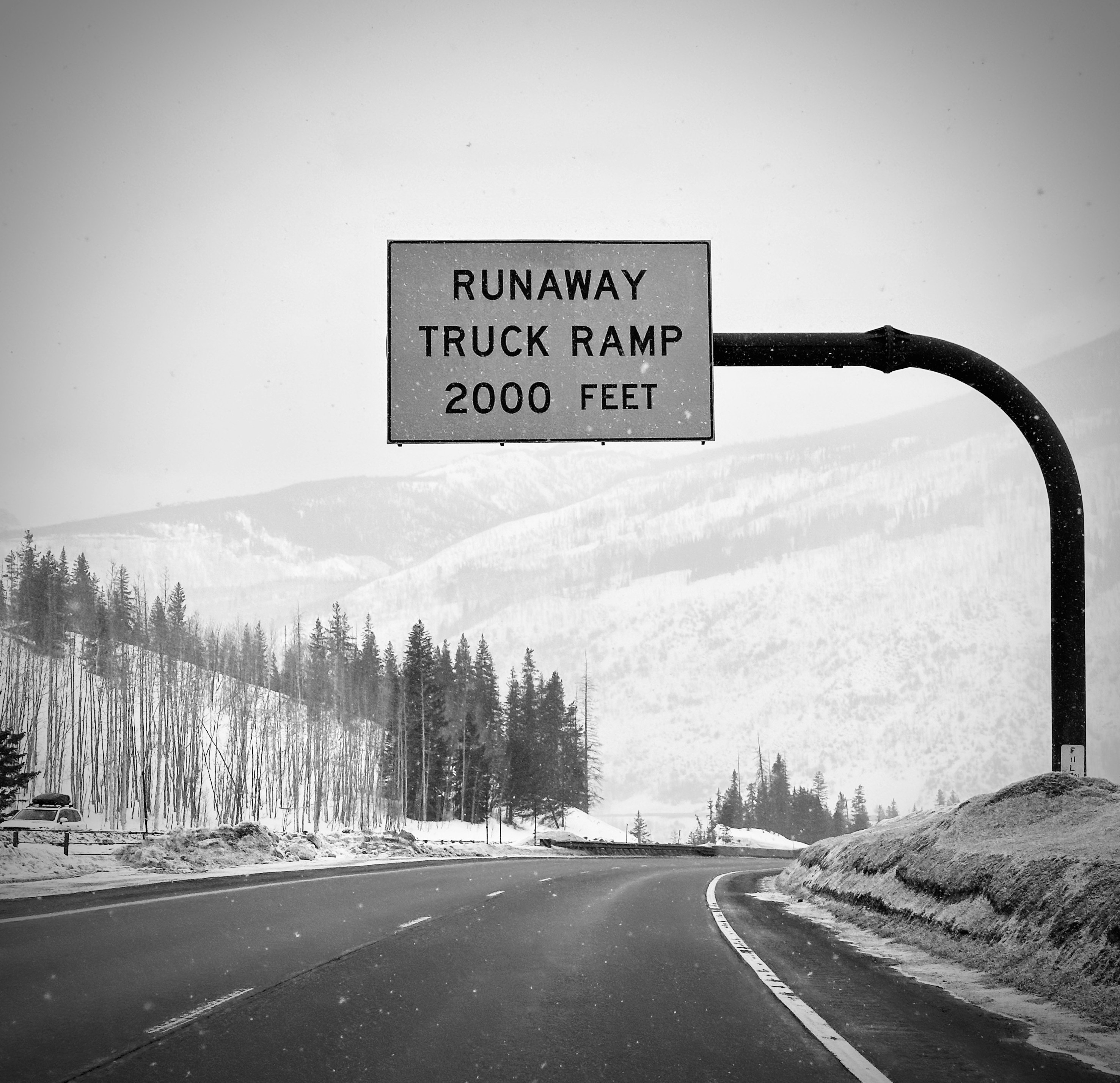 a black and white photo of a road sign