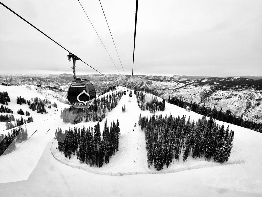 a ski lift going up a snowy mountain